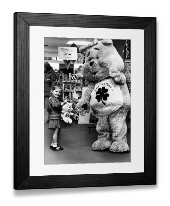 Framed Print : Melissa, aged three, meets the Good Luck Bear during celebrations at Rackhams