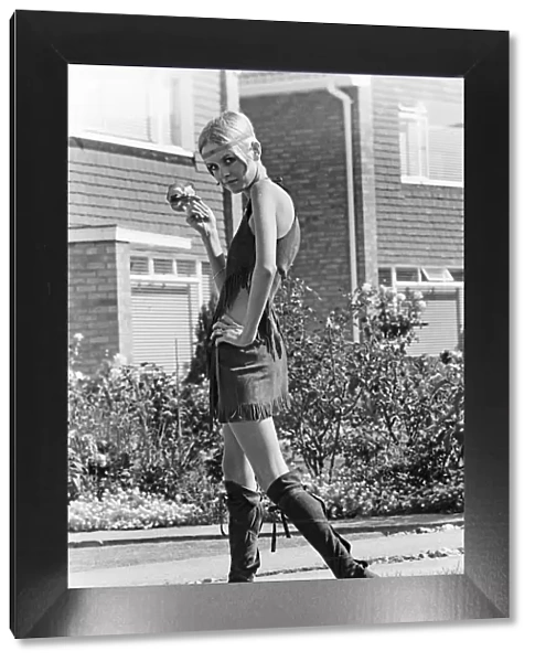 Twiggy, (real name Lesley Hornby) English model, seen in a Hippy gear outfit
