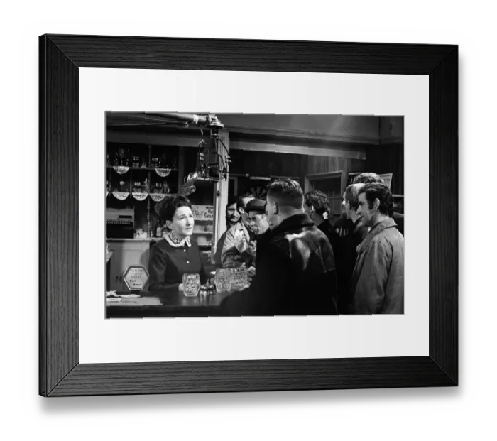Framed Print : The cast of Coronation Street on set. Eileen Derbyshire behind the bar in