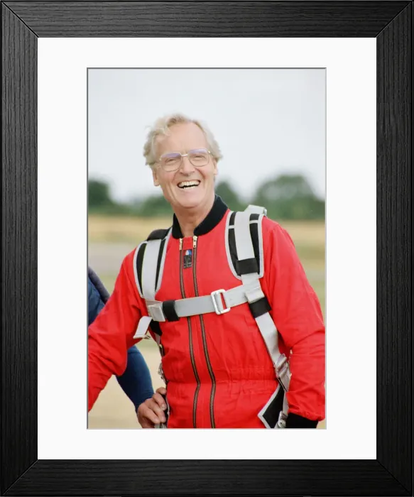 Framed Print : Nicholas Parsons, TV Presenter and actor, preparing for a tandem skydive