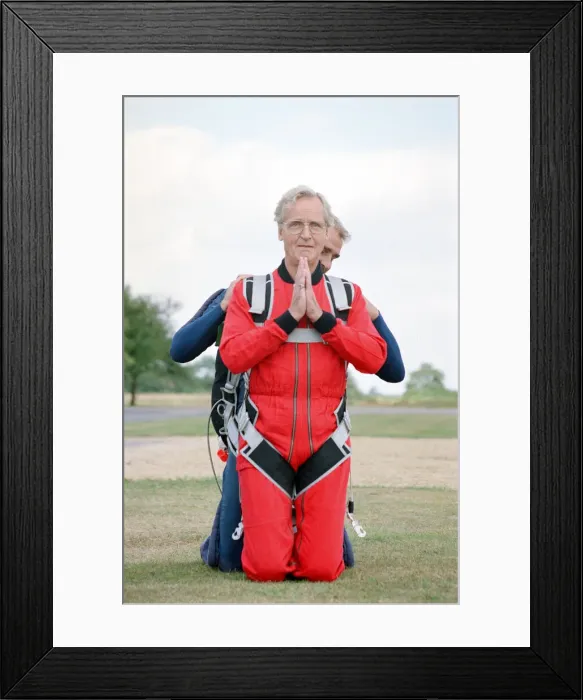 Framed Print : Nicholas Parsons, TV Presenter and actor, preparing for a tandem skydive