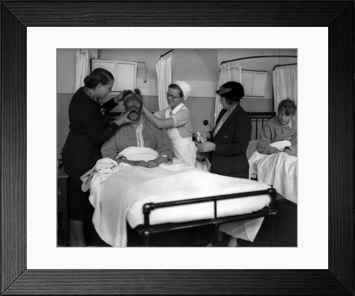 Framed Print : Demonstrating a gas mask on a patient in hospital in the early years of the Second World
