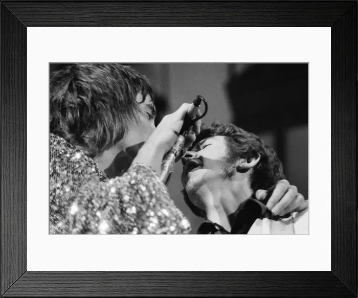 Framed Print : Rod Stewart (left) and bass player Ronnie Lane share the microphone Framed Print : Rod Stewart (left) and bass player Ronnie Lane share the microphone