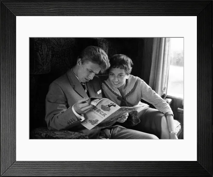 Framed Print : A young couple on a train, reading a copy of Photoplay magazine Framed Print : A young couple on a train, reading a copy of Photoplay magazine