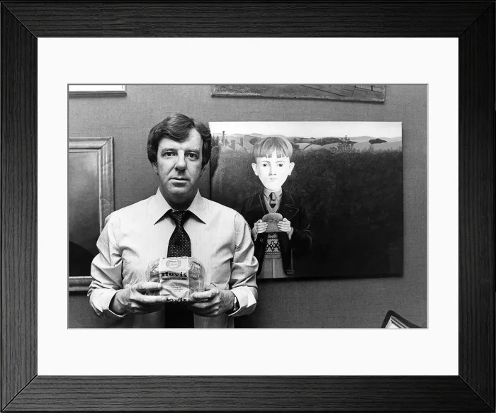 Framed Print : Russell Harty, television presenter at home. He is holding a loaf of Hovis Bread Framed Print : Russell Harty, television presenter at home. He is holding a loaf of Hovis Bread
