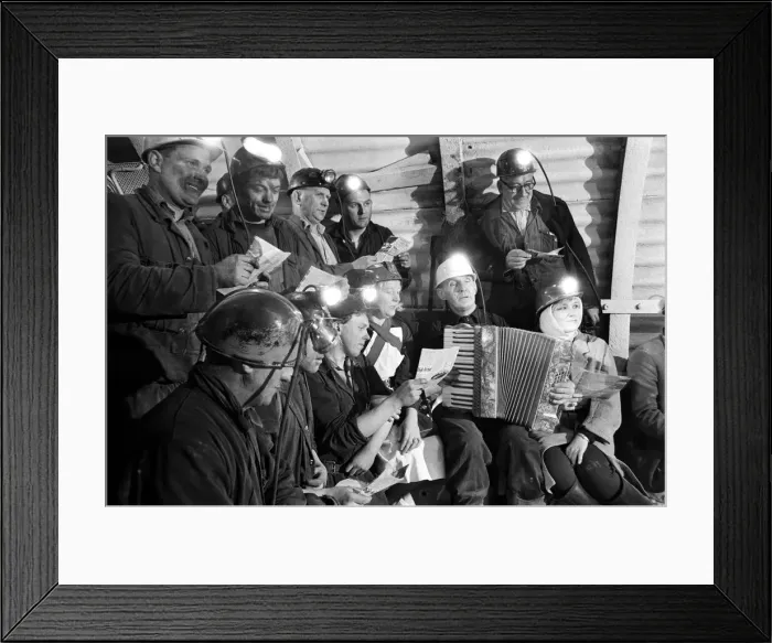 Framed Print : Carol service by miners 600 ft down. An accordion play and miners voices are raised in Framed Print : Carol service by miners 600 ft down. An accordion play and miners voices are raised in