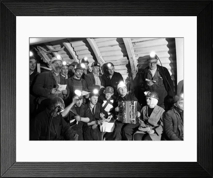 Framed Print : Carol service by miners 600 ft down. An accordion play and miners voices are raised in Framed Print : Carol service by miners 600 ft down. An accordion play and miners voices are raised in