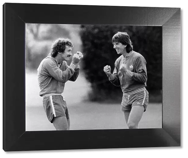Terry McDermott and Paul Mariner, England teammates, having fun during team training