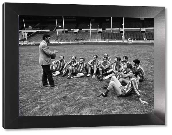 Jimmy Hill pictured talking to a football team. Television presenter Dickie Davies is