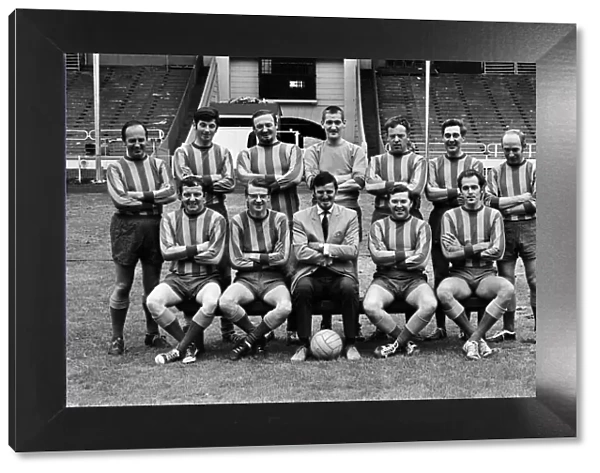 Jimmy Hill pictured (wearing a suit) with a football team