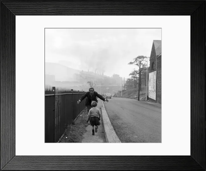 Framed Print : A young boy running into the arms of a man. Ebbw Vale, Blaenau Gwent, Wales Framed Print : A young boy running into the arms of a man. Ebbw Vale, Blaenau Gwent, Wales