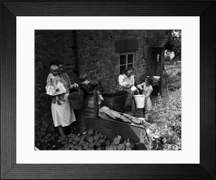 Framed Print : A village without water at Ruyton-XI-Towns, Shropshire. Churns are placed outside each Framed Print : A village without water at Ruyton-XI-Towns, Shropshire. Churns are placed outside each