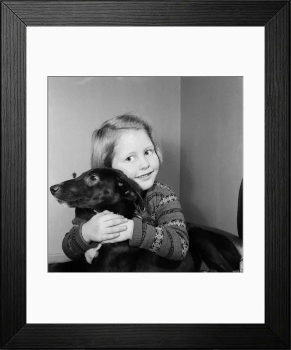 Framed Print : Helen Windle, aged 5, of Doncaster, with Janey, the puppy she helped save from a dogs Framed Print : Helen Windle, aged 5, of Doncaster, with Janey, the puppy she helped save from a dogs