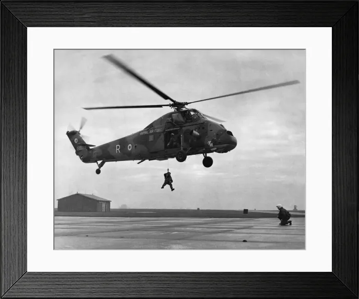 Framed Print : Dry winching drill. A Westland Wessex HC2 helicopter of 75 Squadron which is standing in Framed Print : Dry winching drill. A Westland Wessex HC2 helicopter of 75 Squadron which is standing in