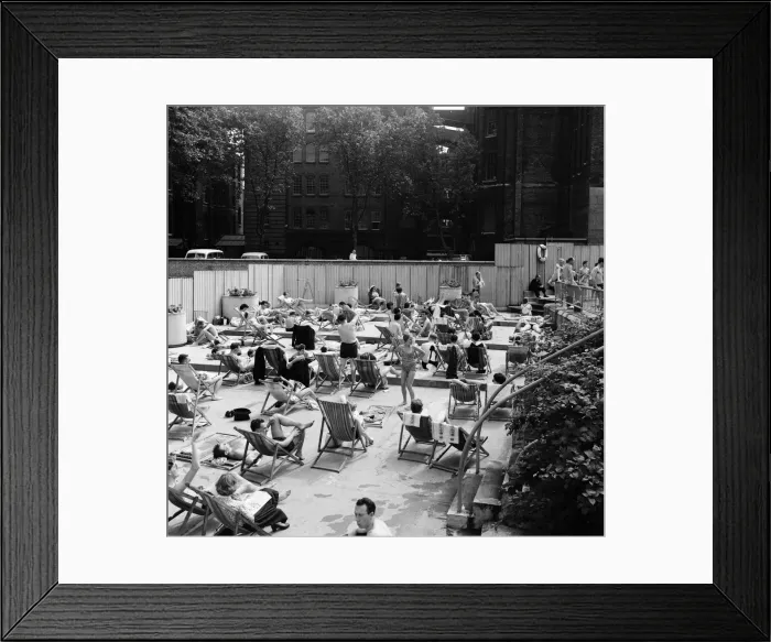 Framed Print : People enjoying the warm weather at Endell Street open air baths, London. 5th August 1954