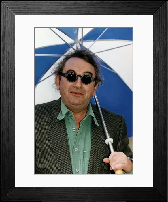 Framed Print : Ian McCaskill wearing a pair of Debenhams Mondo Sunglasses holding umbrella Framed Print : Ian McCaskill wearing a pair of Debenhams Mondo Sunglasses holding umbrella
