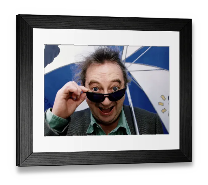 Framed Print : Ian McCaskill peering over the rim of a pair of Marks and Spencer Active Sunglasses Framed Print : Ian McCaskill peering over the rim of a pair of Marks and Spencer Active Sunglasses