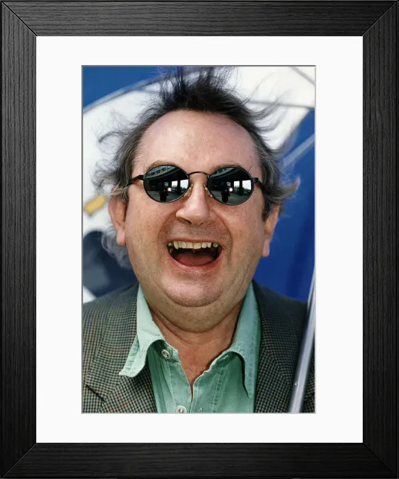 Framed Print : Ian McCaskill wearing a pair of Boots Dial Sunglasses holding umbrella