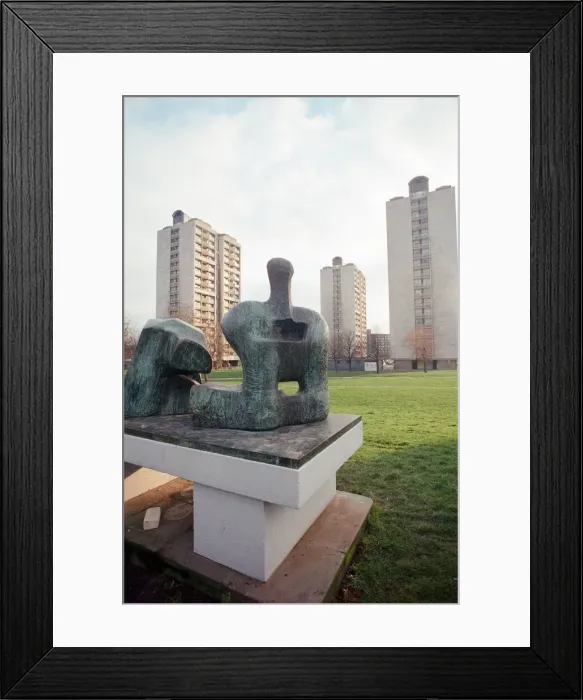 Framed Print : Two Piece Reclining Figure No 3 sculpture by Henry Moore. General views of tower blocks
