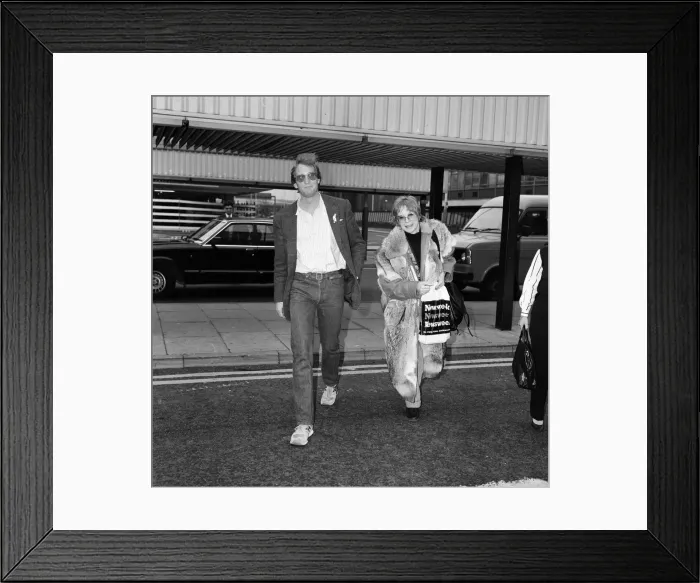 Framed Print : Shirley MacLaine leaving Heathrow Airport for Washington being seen off by Charles Dance Framed Print : Shirley MacLaine leaving Heathrow Airport for Washington being seen off by Charles Dance