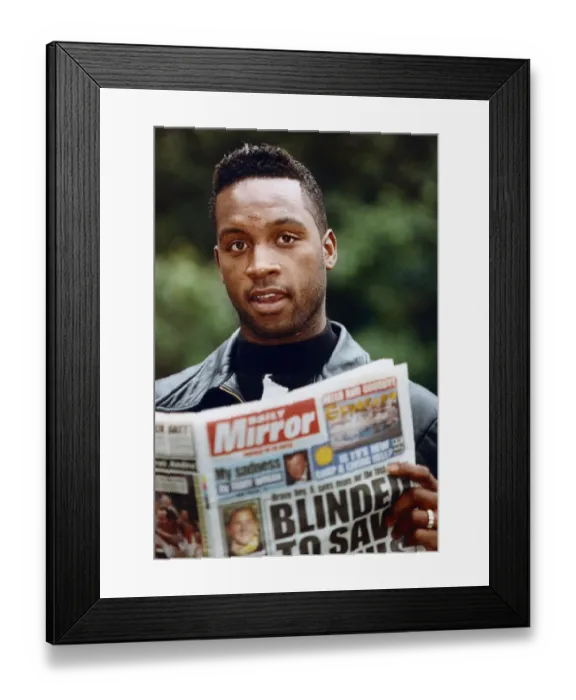 Framed Print : British boxer Nigel Benn with a copy of the Daily Mirror. 3rd July 1992