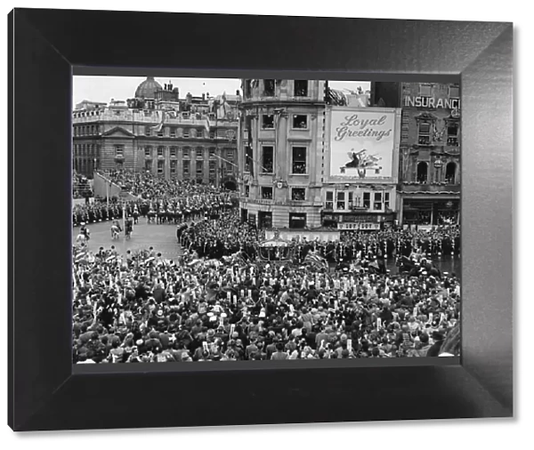 The Queen in her carriage passing through Trafalgar Square on her way to her Coronation