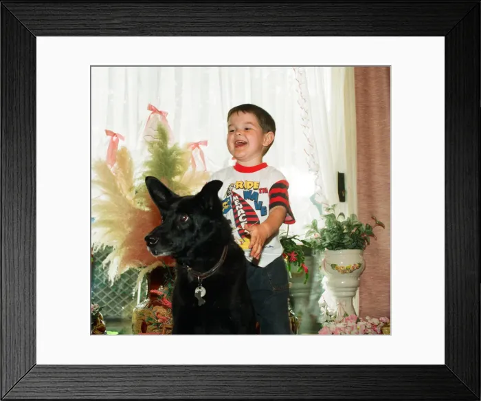 Framed Print : Blackie the dog is pictured with a small boy. 17th June 1993 Framed Print : Blackie the dog is pictured with a small boy. 17th June 1993