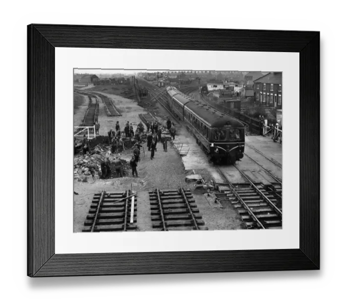 Framed Print : Construction crew seen here working against the clock to complete the laying of a new Framed Print : Construction crew seen here working against the clock to complete the laying of a new