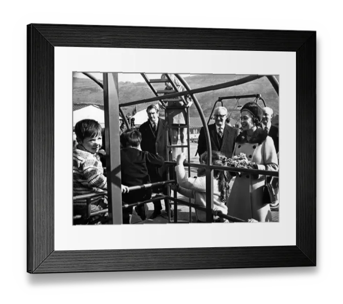 Framed Print : A smiling Queen Elizabeth II watches children in the play area at the opening of Aberfan