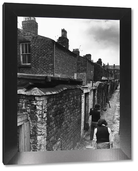Workmen making general improvements to the narrow back passageways of a street in Everton
