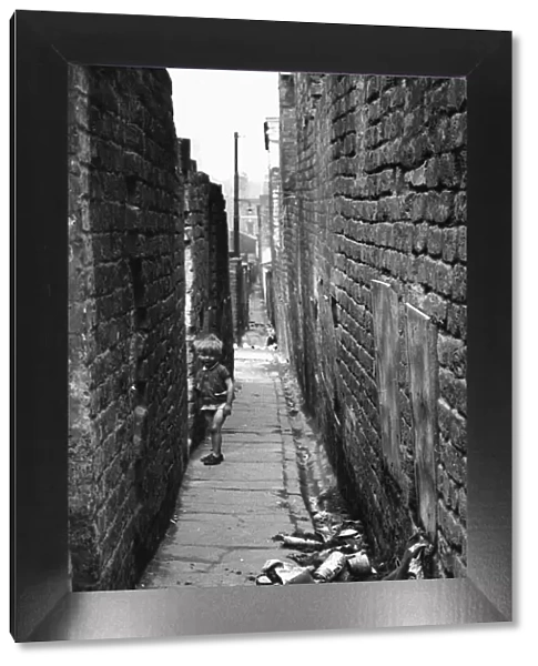 Child playing in alleyway at rear of Gordon Street and Elias Street, Toxteth, Liverpool