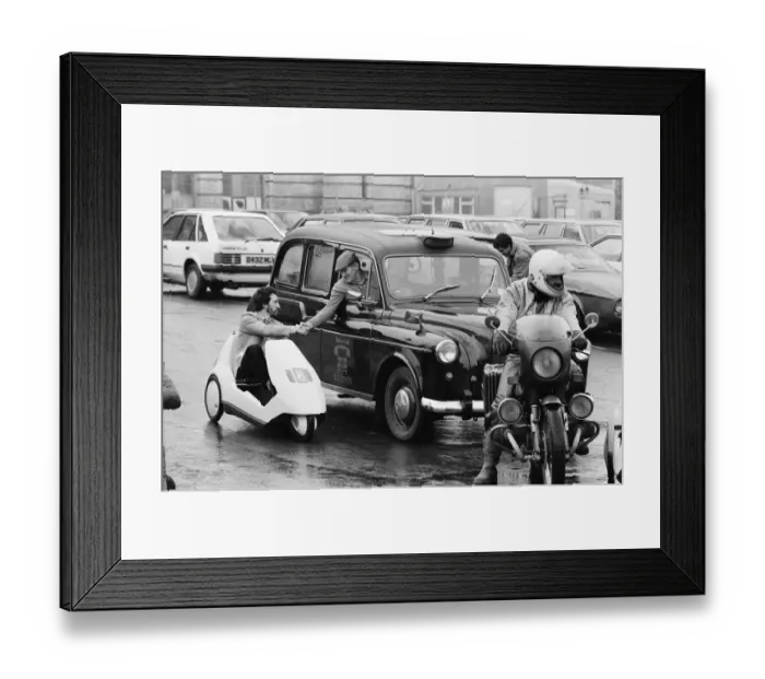 Framed Print : The New Electric Vehicle Picture shows a gentleman in London driving Framed Print : The New Electric Vehicle Picture shows a gentleman in London driving