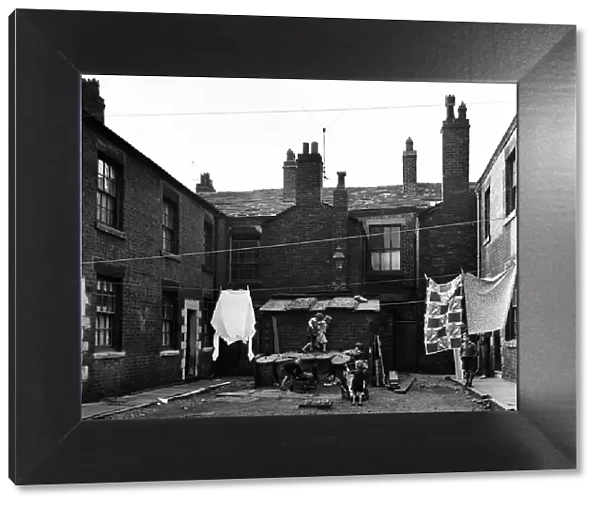 Children playing outside slum housing Number Two Court, Dickenson Street, Oldham