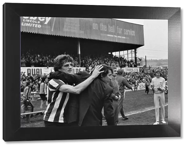 Lincoln manager Graham Taylor and star player Percy Freeman celebrate takes to the pitch