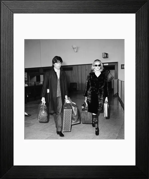 Framed Print : Catherine Deneuve, actress, and husband fashion photographer David Bailey arrive Framed Print : Catherine Deneuve, actress, and husband fashion photographer David Bailey arrive