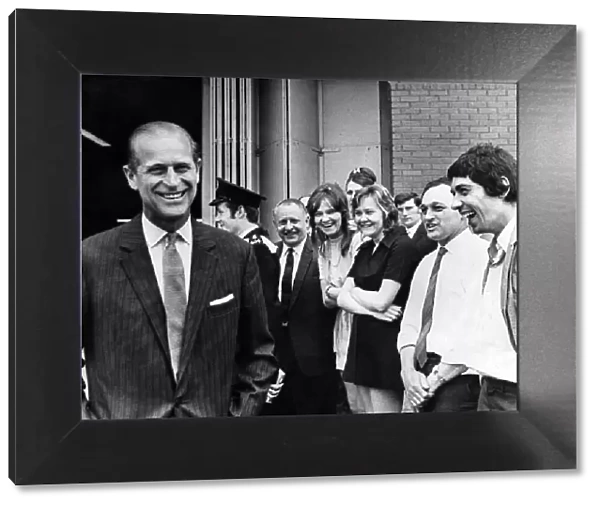 Prince Philip visiting Wales. A smiling Duke of Edinburgh turns after talking to workers