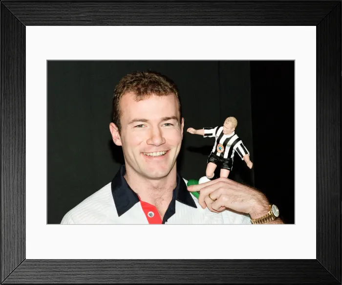 Framed Print : Alan Shearer holding his soccer figure from the Soccer Superheroes collection