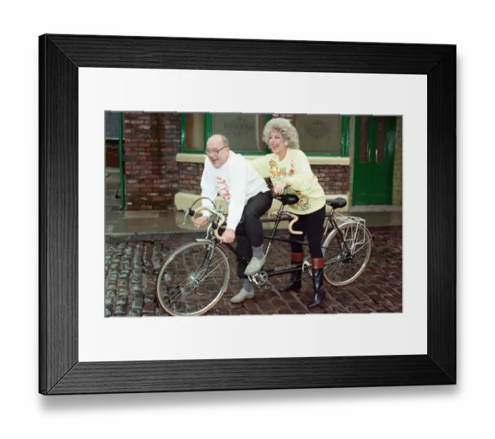 Framed Print : Julie Goodyear and Roy Barraclough pictured on a tandem bike on the set of Coronation Framed Print : Julie Goodyear and Roy Barraclough pictured on a tandem bike on the set of Coronation