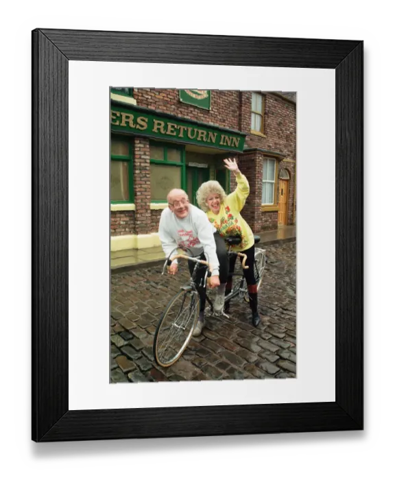 Framed Print : Julie Goodyear and Roy Barraclough pictured on a tandem bike on the set of Coronation