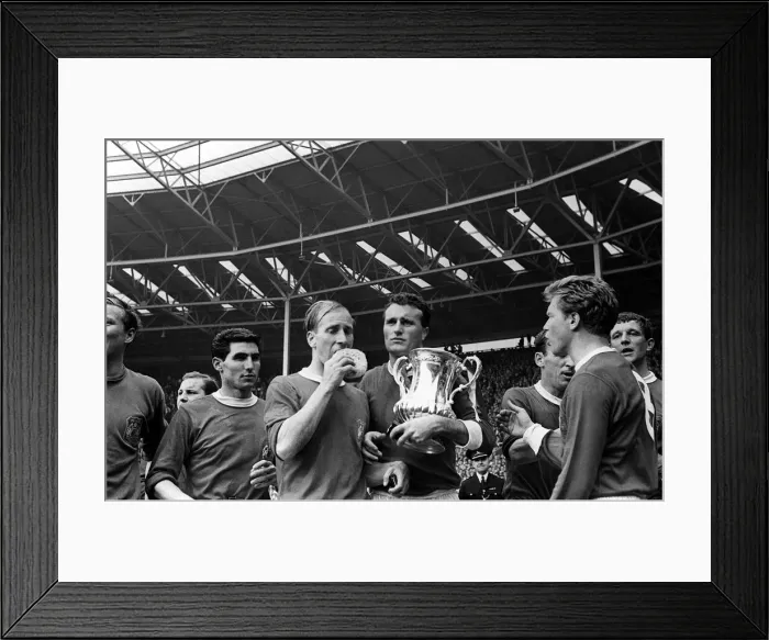 Framed Print : Bobby Charlton with sponge and Noel Cantwell holding the trophy after beating Leicester
