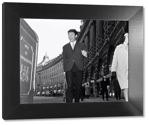 Elated comedian Jimmy Tarbuck walking along Regent Street