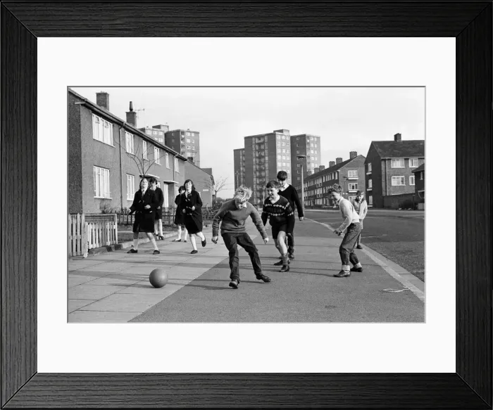 Framed Print : A typical street in Kirkby, Liverpool. Boys playing football in the street Framed Print : A typical street in Kirkby, Liverpool. Boys playing football in the street