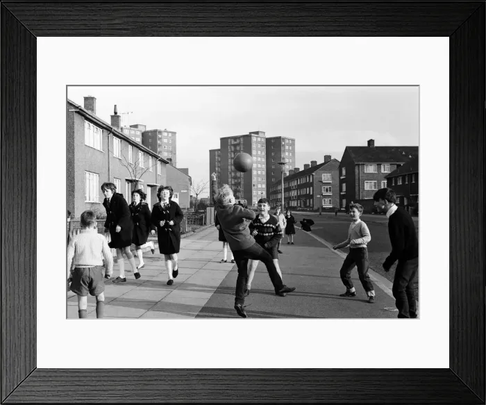 Framed Print : A typical street in Kirkby, Liverpool. Boys playing football in the street Framed Print : A typical street in Kirkby, Liverpool. Boys playing football in the street