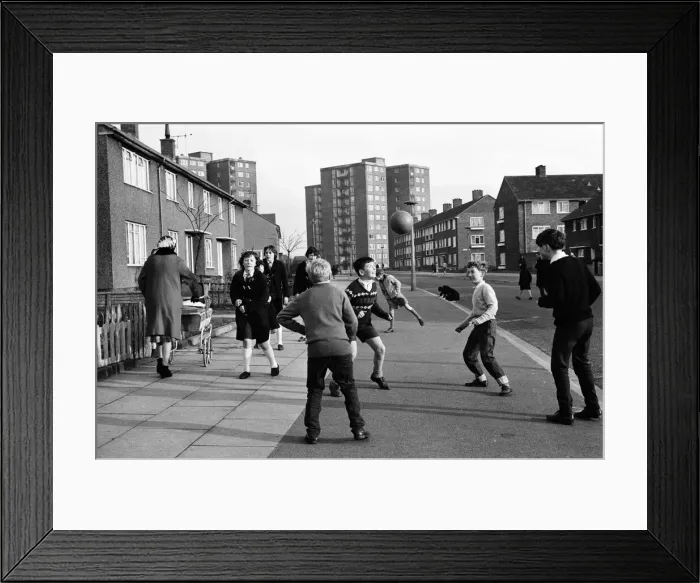 Framed Print : A typical street in Kirkby, Liverpool. Boys playing football in the street Framed Print : A typical street in Kirkby, Liverpool. Boys playing football in the street