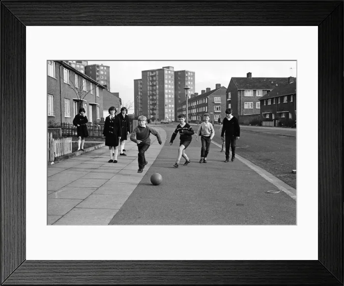 Framed Print : A typical street in Kirkby, Liverpool. Boys playing football in the street Framed Print : A typical street in Kirkby, Liverpool. Boys playing football in the street