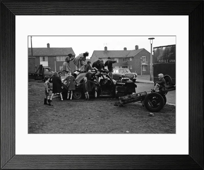 Framed Print : Children play on the wreck of a dumped car at Kirkby, Liverpool. 18th March 1965 Framed Print : Children play on the wreck of a dumped car at Kirkby, Liverpool. 18th March 1965