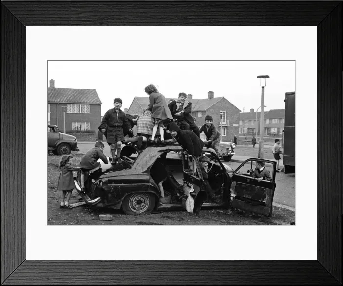 Framed Print : Children play on the wreck of a dumped car at Kirkby, Liverpool. 18th March 1965 Framed Print : Children play on the wreck of a dumped car at Kirkby, Liverpool. 18th March 1965