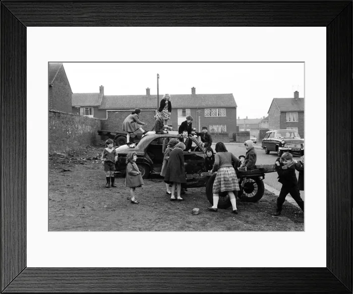 Framed Print : Children play on the wreck of a dumped car at Kirkby, Liverpool. 18th March 1965 Framed Print : Children play on the wreck of a dumped car at Kirkby, Liverpool. 18th March 1965