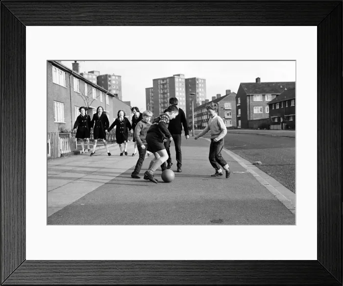 Framed Print : A typical street in Kirkby, Liverpool. Boys playing football in the street Framed Print : A typical street in Kirkby, Liverpool. Boys playing football in the street