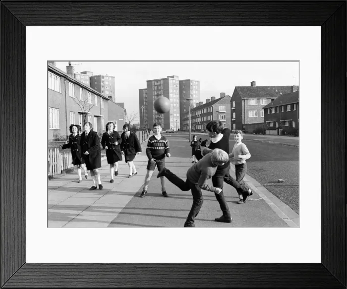 Framed Print : A typical street in Kirkby, Liverpool. Boys playing football in the street Framed Print : A typical street in Kirkby, Liverpool. Boys playing football in the street